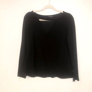 Low cut, black sweater.